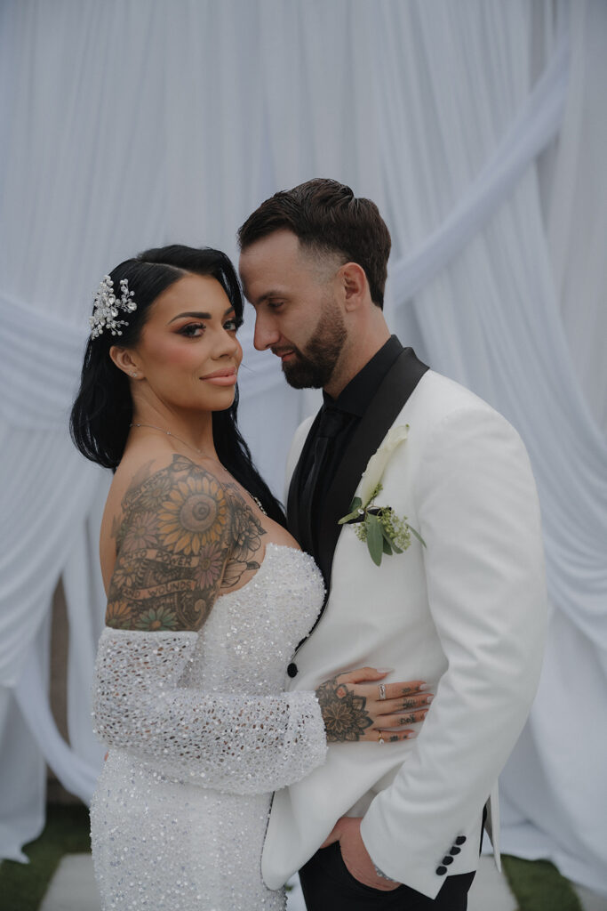 Bride and groom Gianna and Parker sharing a romantic portrait during their backyard wedding in Las Vegas